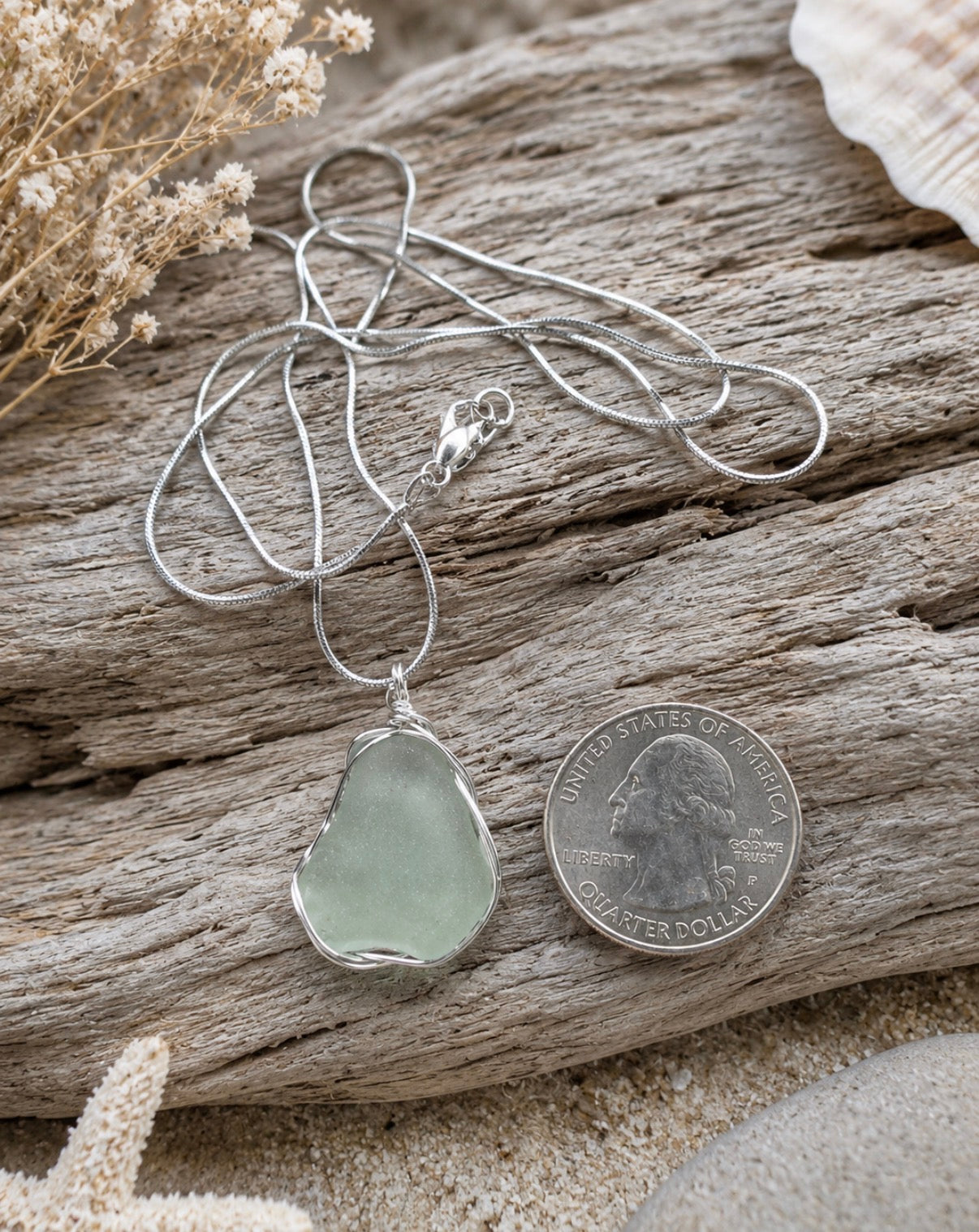 Cola green sea glass pendant wire wrapped in sterling silver, quarter size, on driftwood