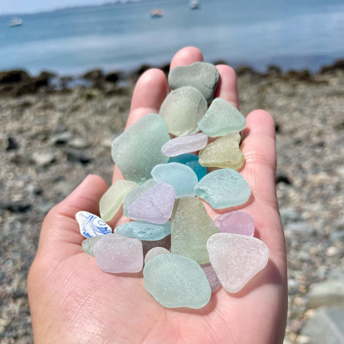 A handful of colorful sea glass pieces collected from a New England beach