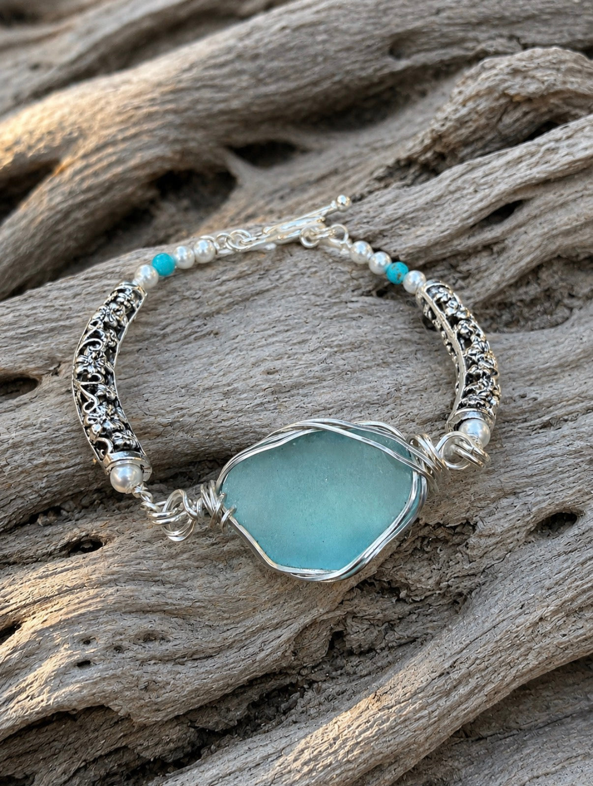 Aqua sea glass bracelet on driftwood