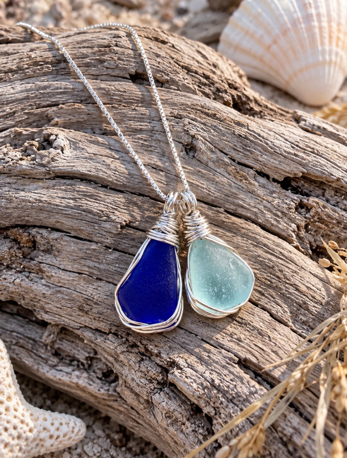 Mermaid Tears cobalt blue and Cola blue sea glass necklace on driftwood
