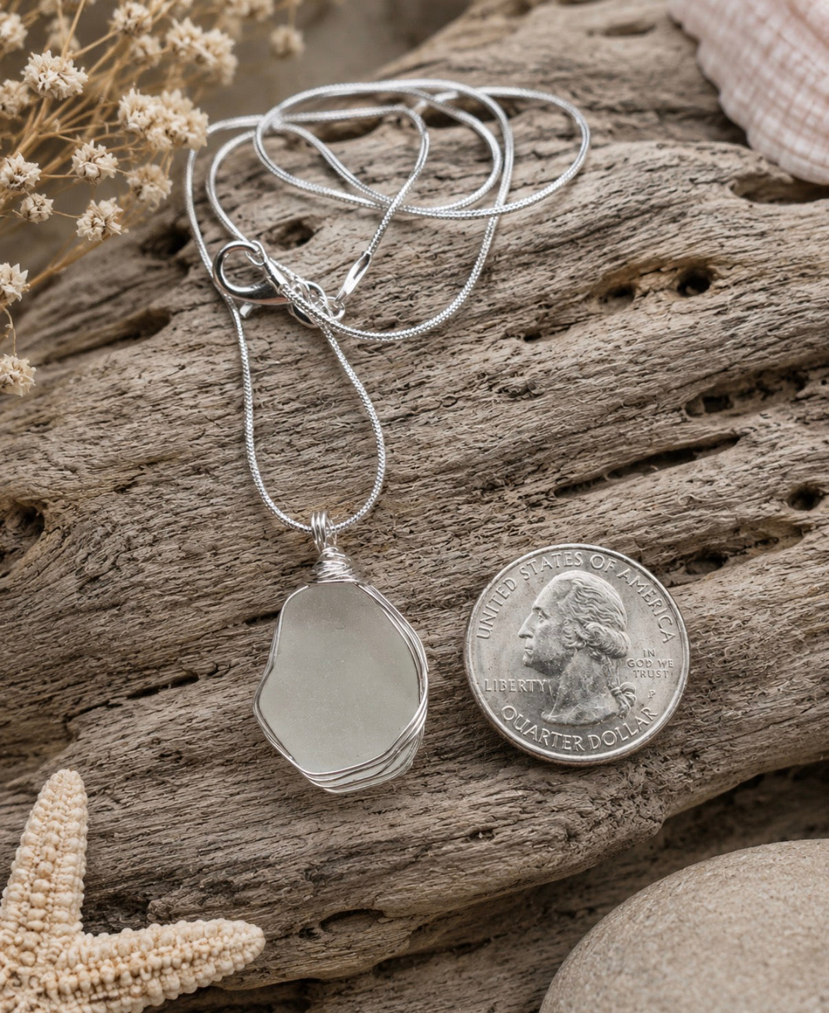 White frosted sea glass pendant wire wrapped in sterling silver, quarter size, on driftwood