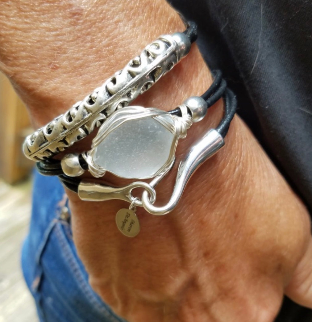 silver grey sea glass bracelet on hand in pocket