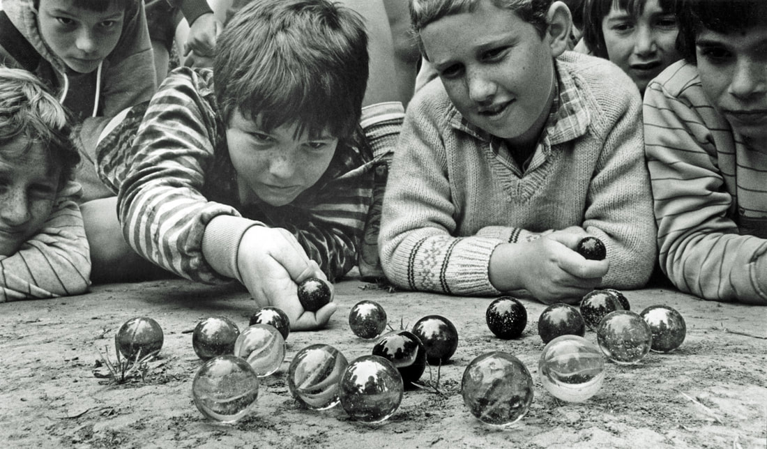 children playing marbles in mid to early 1900s